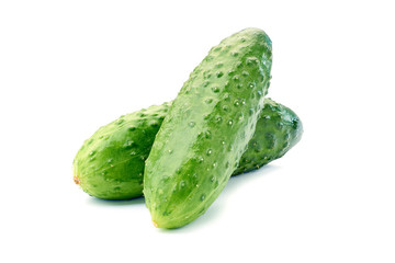 Two fresh cucumbers on white