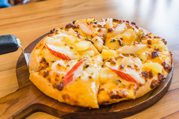 Tropical Seafood Pizza on wooden background