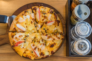Tropical Seafood Pizza on wooden background