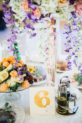 table serving with dishes, fruits and flowers with number 6