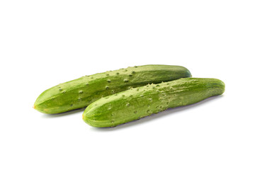 Two fresh cucumbers on white