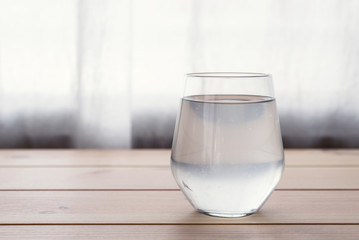 a glass of coconut water on wooden table