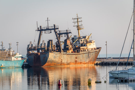 Old rusty shipping boat in the port of vinaros spain