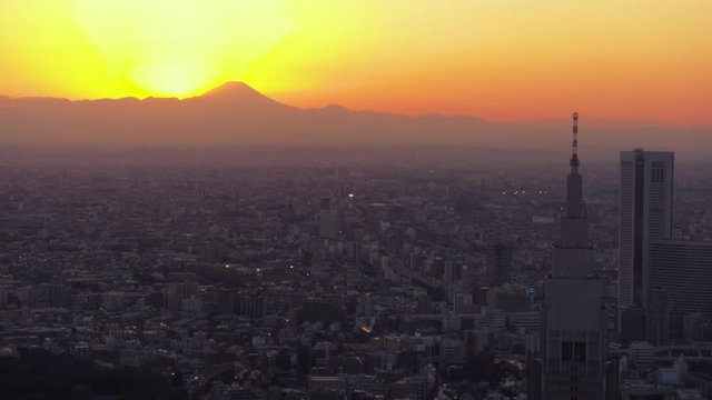 Japan Tokyo Aerial v100 Flying around clock tower with cityscape views sunset Mount Fuji