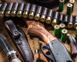 Pump action shotgun, 12 mm hunting cartridge  and hunting knife.