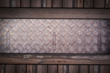 diamond pattern steel plate on wooden background