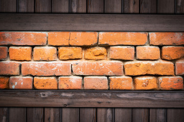 Old grunge brick wall on wooden background