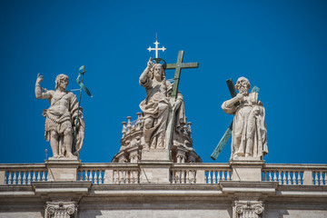 Fototapeta na wymiar Statues on the top of Saint Peter's Basilica in Vatican City, Rome
