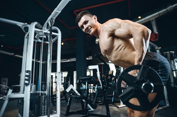 Handsome model young man training back in gym
