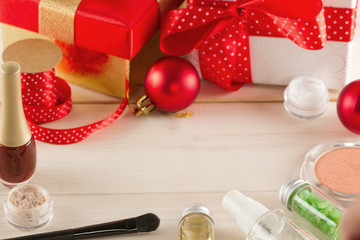 Fototapeta na wymiar Cosmetics set and christmas gift box on white wooden table
