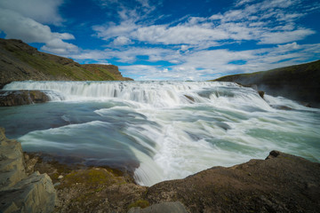Fototapeta na wymiar GULLFOSS, The most famoust Icelandic waterfall, The Golden Falls of Gullfoss, Summer time in Iceland
