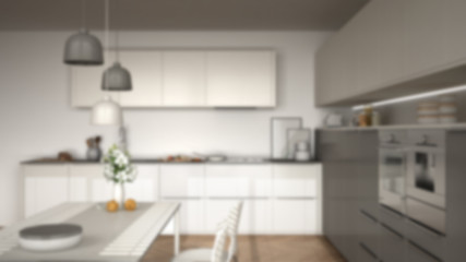 Fototapeta na wymiar Blur background interior design, modern kitchen with table and chairs, herringbone parquet floor