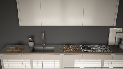 Modern kitchen with sink and stove, cooking pan and food, close-up, top view, white and gray minimalist interior design