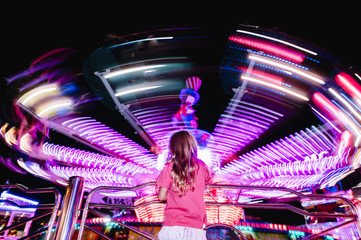 little girl looking at the carousel
