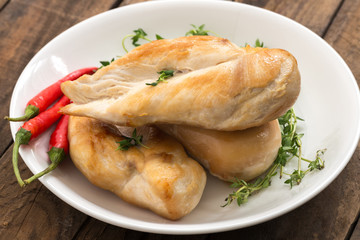 chicken breast with vegetable and chili on plate

