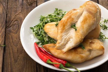chicken breast with vegetable and chili on plate

