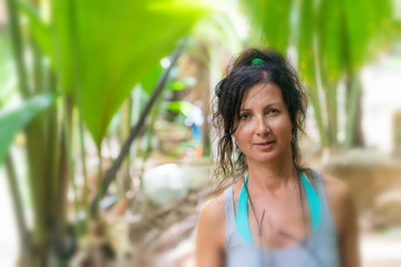 Beautiful woman walking along tropical forest