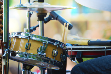 Drummer playing in a live show with a music band. Day time. Empty copy space for Editor's text.