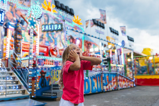 Little girl  in the summer amusement park