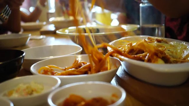 Family Busy Hands Enjoys Eating Hot Foods On Table At Restaurant