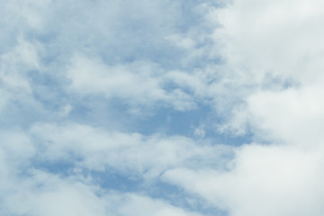 Blue sky background with tiny clouds. White fluffy clouds in the blue sky