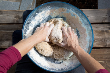 Female hands kneading sourdough