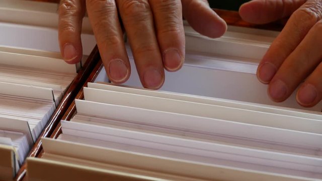 man's hand looking at a file