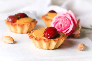 almond cake with strawberries on a white background selective soft focus