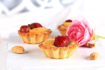 almond cake with strawberries on a white background selective soft focus