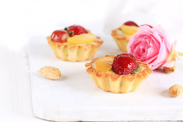 almond cake with strawberries on a white background selective soft focus