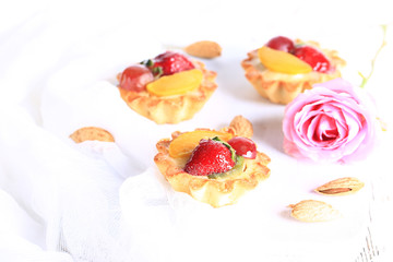 almond cake with strawberries on a white background selective soft focus