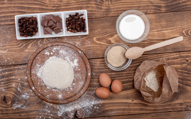 Fototapeta na wymiar Food ingredients for dough a wooden kitchen board. Cake recipies