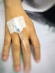 Patient hands have a needle for the saline solution.