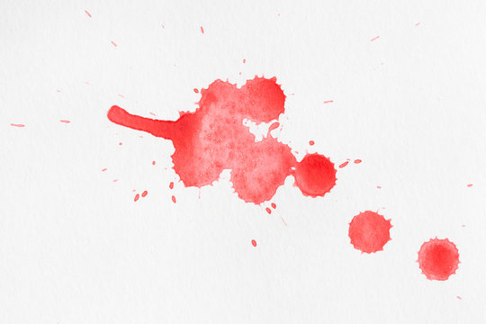 Red blobs of watercolor paint