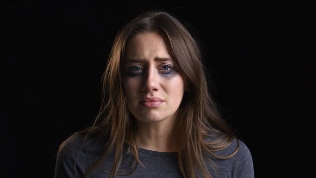Studio Portrait Shot Of Crying Woman With Smudged Make Up 