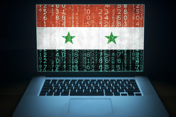 Syrian computer system. Laptop with binary computer code and Syria flag on the screen. Syrian...