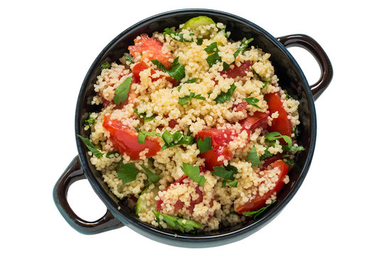Bowl with couscous, vegetables and herbs on white background