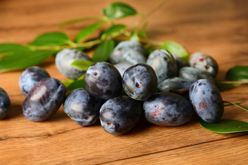 pile of plums on wooden table