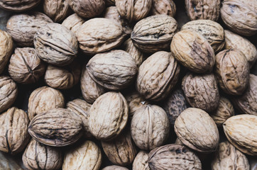 Walnuts presented on a wooden plate around christmas / autumn season