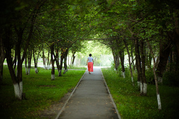 a woman walks through the alley back