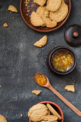 Cookies and orange jam on dark background, copy space. Dessert concept