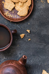 Cookies and tea on dark background, copy space. Dessert concept