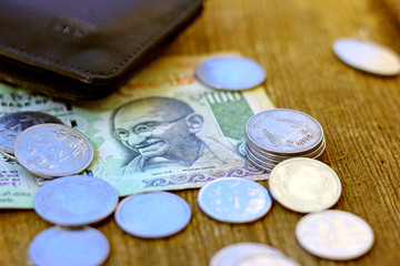 Indian coin on wooden texture ,