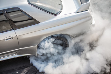 Rear wheel drive super sport car burning tire for warm up before competition to increase type temperature for good traction and grip. © pichitstocker