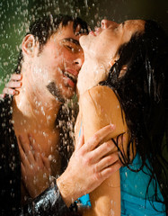 Young couple hugging under a rain