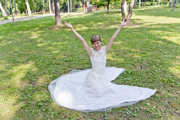 Beautiful bride in white lace dress of summer time