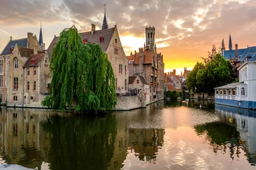 Fotobehang Bruges (Brugge) cityscape with water canal at sunset © haveseen
