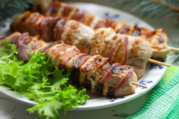 Pork shish kebab with fir branches, rowan and green leaf of lettuce cooked on the grill for Christmas dinner for the designer