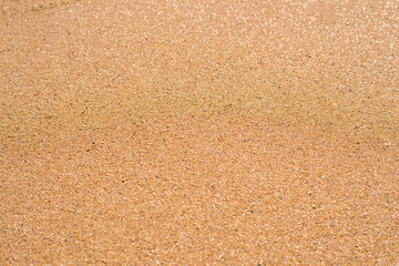 Fototapeta na wymiar Texture of smooth surface of wet sand, background