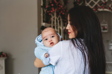 Happy asian mother holding adorable child baby boy.